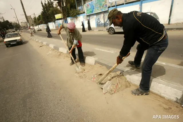 Palestinian volunteers cleaning the streets to mark "workers' Day" in Rafah town In Gaza Strip, on May 01, 2012. Photo by Eyad Al Baba