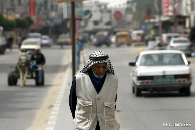 A Palestinian man walks in the street during cleaning the streets " to mark workers' Day in Rafah town In Gaza Strip, on May 01, 2012. Photo by Eyad Al Baba