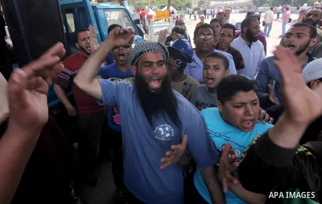 Egyptian Protesters shout slogans against military rulers in front of the Ministry of Defense in the Abbassiya district of Cairo on May 01, 2012. Protesters demanded that their military rulers pledge to hand over power b...