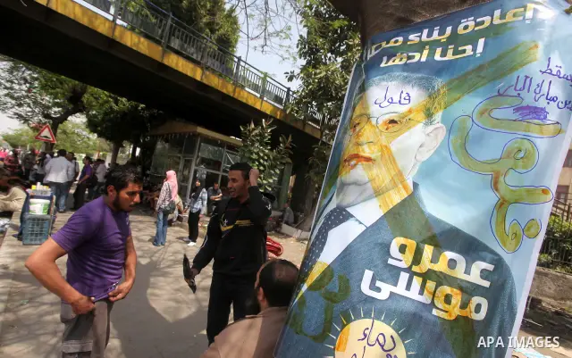 Egyptian Protesters shout slogans against military rulers in front of the Ministry of Defense in the Abbassiya district of Cairo on May 01, 2012. Protesters demanded that their military rulers pledge to hand over power b...