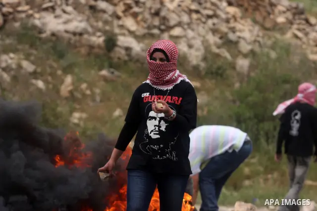 Palestinian protesters throw stones at Israeli troops during a demonstration outside Ofer military prison near the West Bank city of Ramallah on May 1, 2012 in a show of support for prisoners held in Israeli jails. Clash...