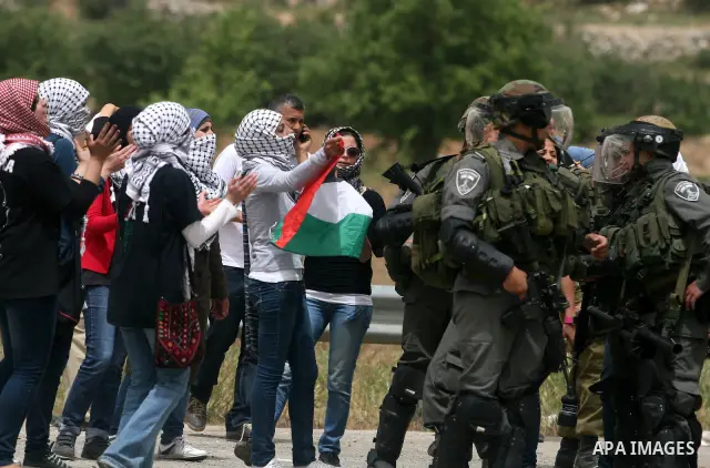 Palestinian women shout slogans against Israeli troops outside Ofer military prison near the West Bank city of Ramallah on May 1, 2012 during a demonstration in support for prisoners held in Israeli jails. Clashes erupte...