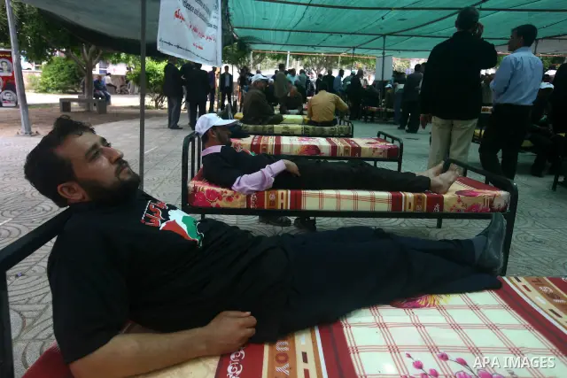Palestinians participat at hunger striking during a rally held by hunger striking activists in solidarity with Palestinians prisoners held in Israeli jails, in Gaza City, Wednesday, May 2, 2012. A Palestinian rights grou...