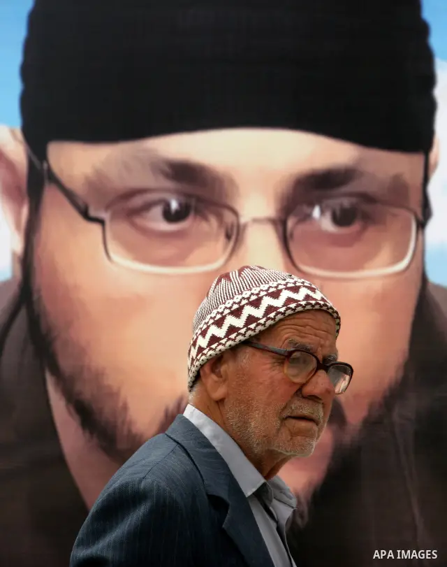 A Palestinian man looks at posters of Palestinian prisoners, during a rally held by hunger striking activists in solidarity with Palestinians prisoners held in Israeli jails, in Gaza City, Wednesday, May 2, 2012. A Pales...
