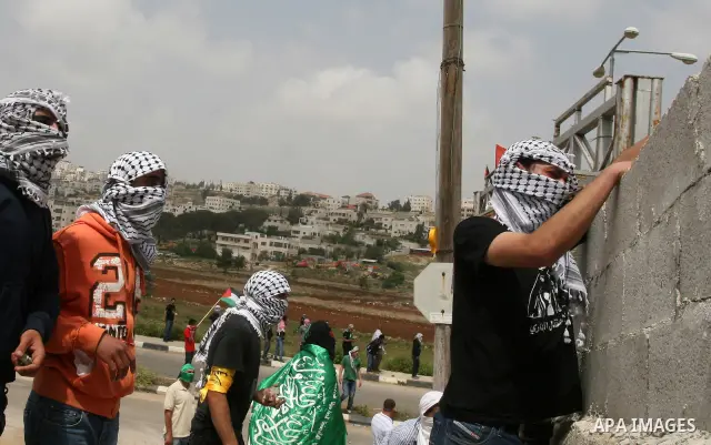 Palestinians throw stones at Israeli soldiers during clashes next to the Israeli military prison of Ofer, near Beitunia, West Bank, 02 May 2012. The protesters were protesting in solidarity with the Palestinian prisoners...