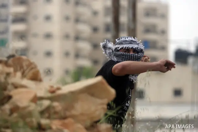 Palestinians throw stones at Israeli soldiers during clashes next to the Israeli military prison of Ofer, near Beitunia, West Bank, 02 May 2012. The protesters were protesting in solidarity with the Palestinian prisoners...