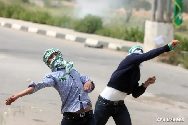 Palestinians throw stones at Israeli soldiers during clashes next to the Israeli military prison of Ofer, near Beitunia, West Bank, 02 May 2012. The protesters were protesting in solidarity with the Palestinian prisoners...