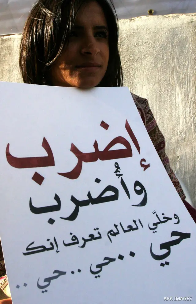Palestinian protesters hold up banners and portraits of a prisoners jailed in Israel, during a Sit-in held outside the International Committee of the Red Cross (ICRC) in the West Bank, city of Jerusalem, May 02, 2012. Ov...