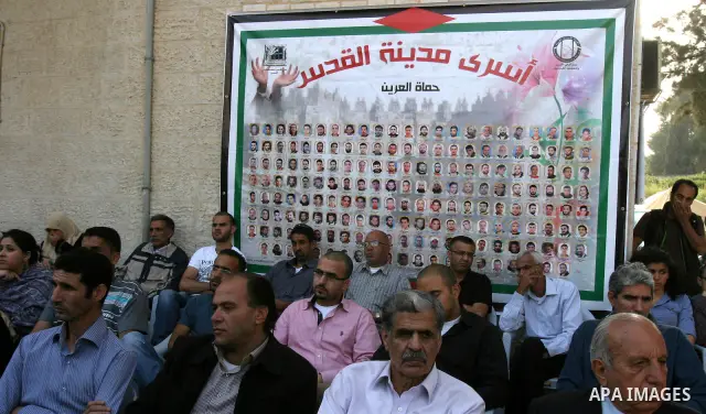 Palestinian protesters hold up banners and portraits of a prisoners jailed in Israel, during a Sit-in held outside the International Committee of the Red Cross (ICRC) in the West Bank, city of Jerusalem, May 02, 2012. Ov...