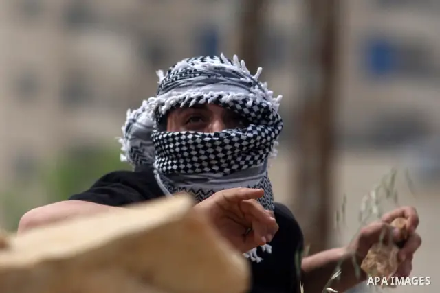 A Palestinian youth throw stones at Israeli soldiers during clashes next to the Israeli military prison of Ofer, near Beitunia, West Bank, 02 May 2012. The protesters were protesting in solidarity with the Palestinian pr...