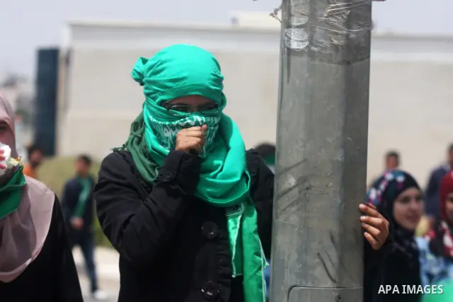 A Palestinian protester chokes from tear gas fired by Israeli troops during clashes next to the Israeli military prison of Ofer, near Beitunia, West Bank, 02 May 2012. The protesters were protesting in solidarity with th...