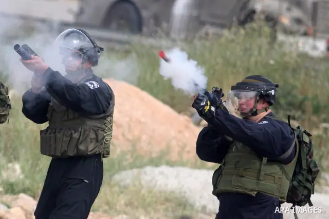 Israeli troops fired tear gas fired near Palestinian stone-throwers during clashes next to the Israeli military prison of Ofer, near Beitunia, West Bank, 02 May 2012. The protesters were protesting in solidarity with the...