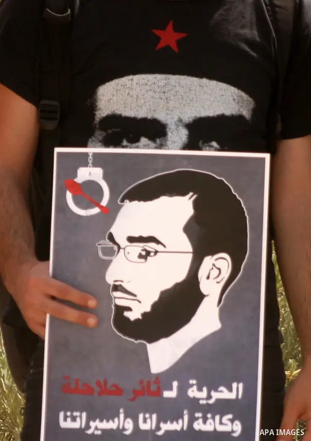 Palestinians and Israeli Arab protesters hold posters depicting Palestinian hunger strikers Thaer Halahla and Bilal Thiab (R) who are in administrative detention during a protest outside Israel's Supreme Court in Jerusal...