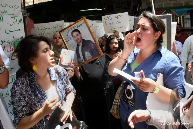 Palestinian protesters hold up pictures and portraits of a prisoners jailed in Israel, during a rally in solidarity with prisoners in Israeli jails, in the West Bank city of Nablus, 03 May, 2012. Over 1,350 Palestinian p...