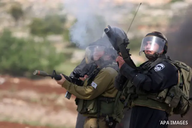 Israeli troops fire tear gas and rubber bullets towards Palestinian stone-throwers during clashes next to the Israeli military prison of Ofer, near Beitunia, West Bank, 03 May 2012. following a demonstration in solidarit...