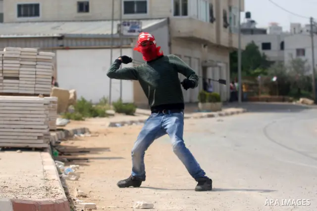 Palestinians throw stones at Israeli soldiers during clashes next to the Israeli military prison of Ofer, near Beitunia, West Bank, 02 May 2012. following a demonstration in solidarity with Palestinian prisoners held in...