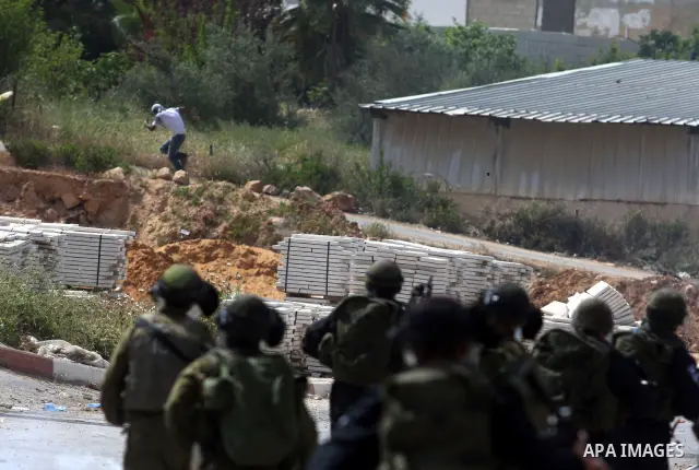 Israeli troops fire tear gas and rubber bullets towards Palestinian stone-throwers during clashes next to the Israeli military prison of Ofer, near Beitunia, West Bank, 03 May 2012. following a demonstration in solidarit...