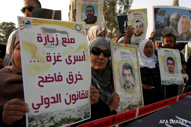 Palestinian protesters hold up banners and portraits of a prisoners jailed in Israel, during a rally next to Al-Ramle Prison, near Tel Aviv, Thursday, May 3, 2012. A Palestinian rights group said recently that half of ab...