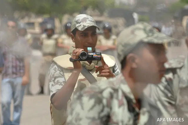 May 4, 2012 - Cairo, Egypt - An Egyptian soldier films protesters as the army deploy extra razor wire to protect the Ministry of Defense ahead of the 'Final Friday' marches planned for May 4, 2012 in the Abasseya neighbo...