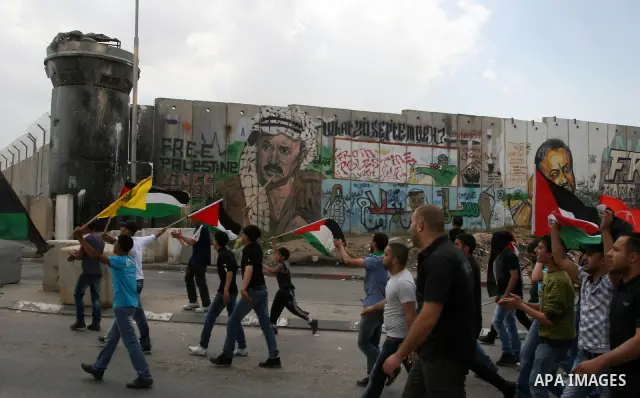 Palestinian men throw stones at Israeli soldiers at the Qalandia crossing in the occupied West Bank during a demonstration on May 4, 2012 in solidarity with Palestinian prisoners on hunger strike to protest Israel's use...