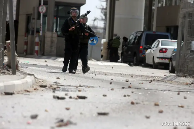 Israeli troops fire tear gas and rubber bullets towards Palestinian stone-throwers during clashes with Palestinian stone-throwers in Qalandia in the occupied West Bank, following a demonstration on May 4, 2012 solidarity...