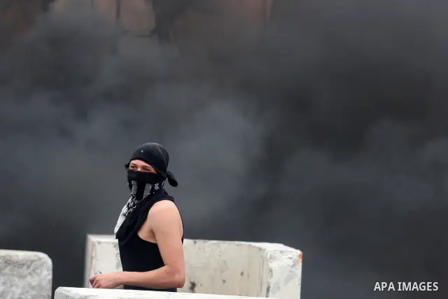 A Palestinian man throws stones at Israeli soldiers at the Qalandia crossing in the occupied West Bank during a demonstration on May 4, 2012 in solidarity with Palestinian prisoners on hunger strike to protest Israel's u...