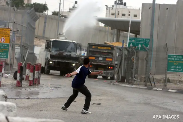 A Palestinian man throws stones at Israeli soldiers at the Qalandia crossing in the occupied West Bank during a demonstration on May 4, 2012 in solidarity with Palestinian prisoners on hunger strike to protest Israel's u...