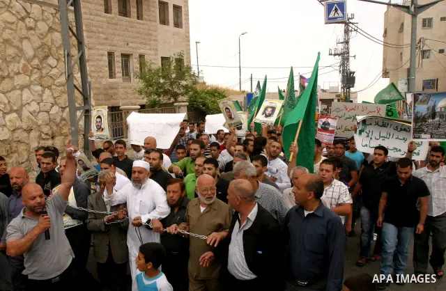Palestinian protesters hold up banners and portraits of a prisoners jailed in Israel, during a Sit-in held in old City of Jerusalem, May 04, 2012. Over the past week, over 1400 Palestinian prisoners have begun an open-en...