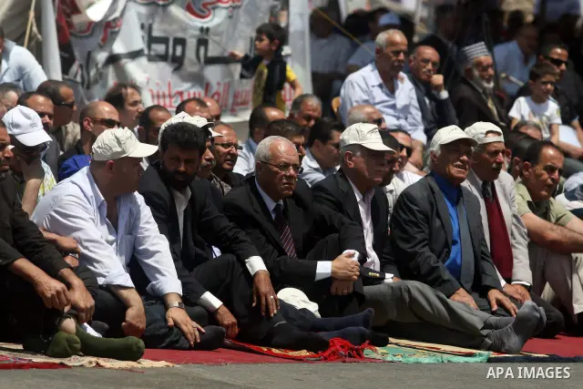 Palestinians perform Friday prayers during protest, in Ramallah, West Bank, May 04, 2012. An estimated 2,000 Palestinians held in prayer outside a tent in solidarity with prisoners who have been waging a hunger strike in...