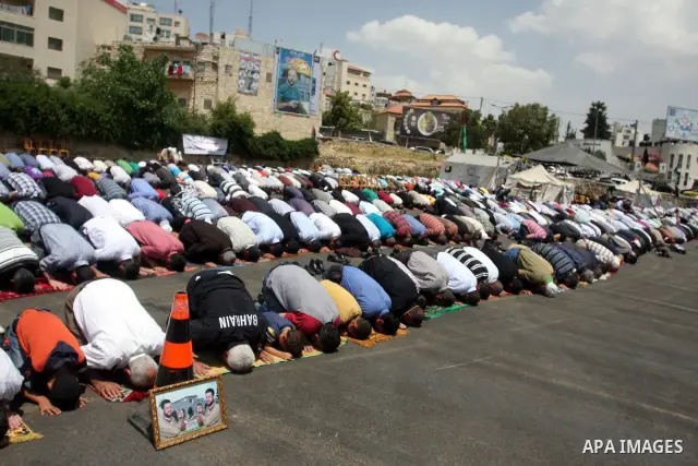 Palestinians perform Friday prayers during protest, in Ramallah, West Bank, May 04, 2012. An estimated 2,000 Palestinians held in prayer outside a tent in solidarity with prisoners who have been waging a hunger strike in...