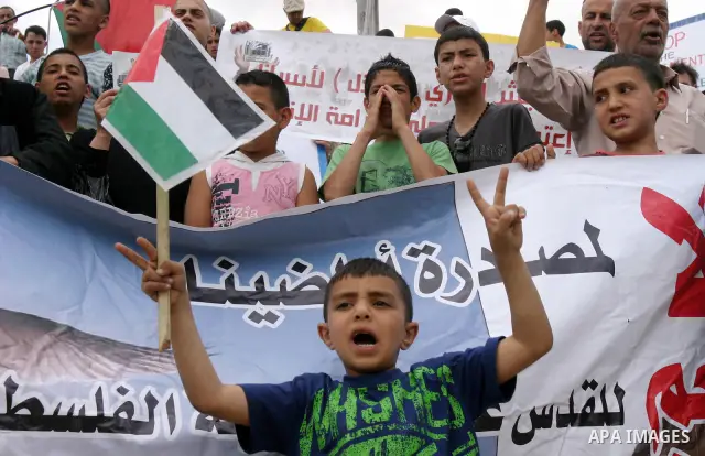 Palestinian protesters hold up banners and portraits of a prisoners jailed in Israel, during a Sit-in held in old City of Jerusalem, May 04, 2012. Over the past week, over 1400 Palestinian prisoners have begun an open-en...
