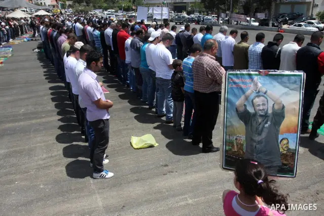 Palestinians perform Friday prayers during protest, in Ramallah, West Bank, May 04, 2012. An estimated 2,000 Palestinians held in prayer outside a tent in solidarity with prisoners who have been waging a hunger strike in...