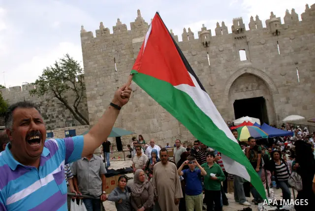 Palestinian protesters hold up banners and portraits of a prisoners jailed in Israel, during a Sit-in held in old City of Jerusalem, May 04, 2012. Over the past week, over 1400 Palestinian prisoners have begun an open-en...