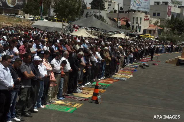 Palestinians perform Friday prayers during protest, in Ramallah, West Bank, May 04, 2012. An estimated 2,000 Palestinians held in prayer outside a tent in solidarity with prisoners who have been waging a hunger strike in...