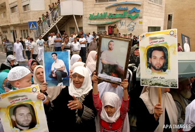 Palestinian protesters hold up banners and portraits of a prisoners jailed in Israel, during a Sit-in held in old City of Jerusalem, May 04, 2012. Over the past week, over 1400 Palestinian prisoners have begun an open-en...