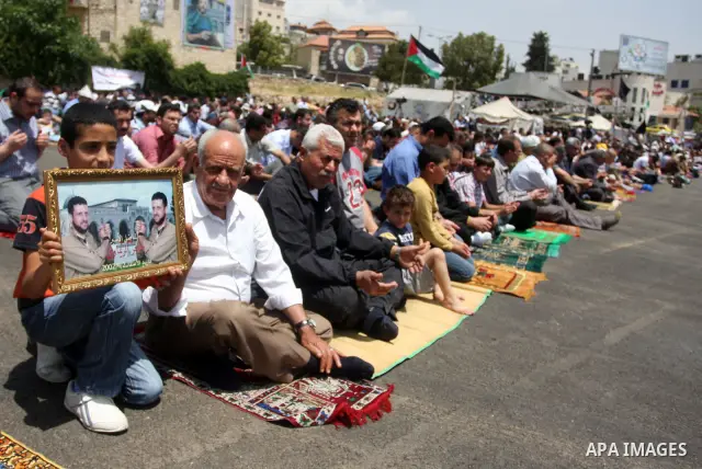 Palestinians perform Friday prayers during protest, in Ramallah, West Bank, May 04, 2012. An estimated 2,000 Palestinians held in prayer outside a tent in solidarity with prisoners who have been waging a hunger strike in...