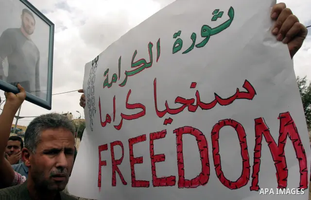 Palestinian protesters hold up banners and portraits of a prisoners jailed in Israel, during a Sit-in held in old City of Jerusalem, May 04, 2012. Over the past week, over 1400 Palestinian prisoners have begun an open-en...