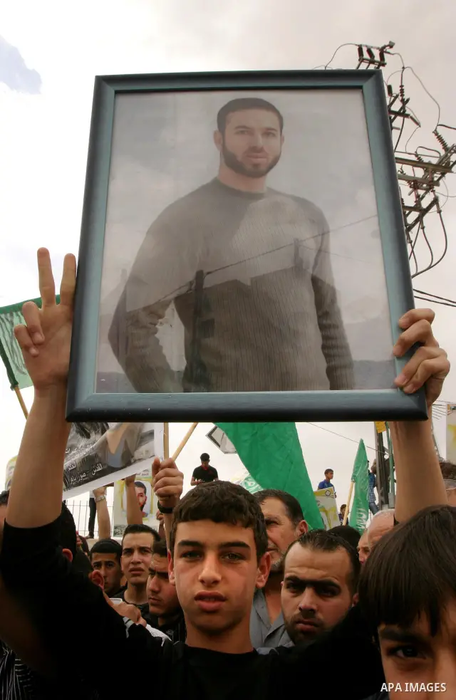 Palestinian protesters hold up banners and portraits of a prisoners jailed in Israel, during a Sit-in held in old City of Jerusalem, May 04, 2012. Over the past week, over 1400 Palestinian prisoners have begun an open-en...