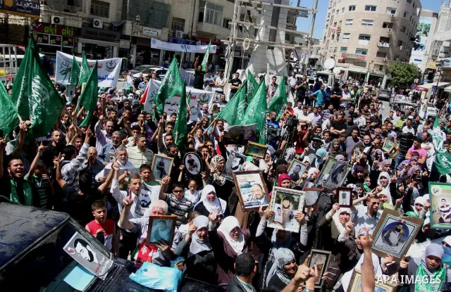 Supporters of the Islamic Hamas movement hold a rally in the West Bank city of Ramallah, calling for the release of prisoners being held in Israeli prisons on May 5, 2012, as ten Palestinian hunger strikers held at an Is...