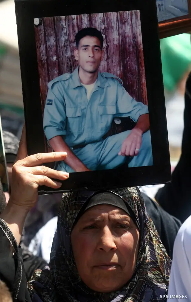 Supporters of the Islamic Hamas movement hold a rally in the West Bank city of Ramallah, calling for the release of prisoners being held in Israeli prisons on May 5, 2012, as ten Palestinian hunger strikers held at an Is...