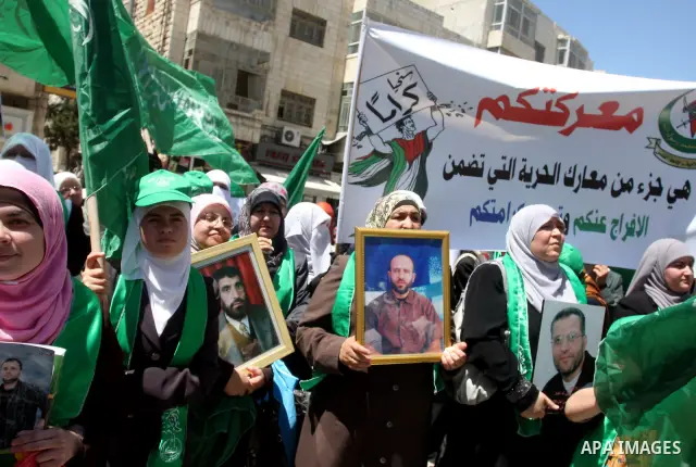 Supporters of the Islamic Hamas movement hold a rally in the West Bank city of Ramallah, calling for the release of prisoners being held in Israeli prisons on May 5, 2012, as ten Palestinian hunger strikers held at an Is...