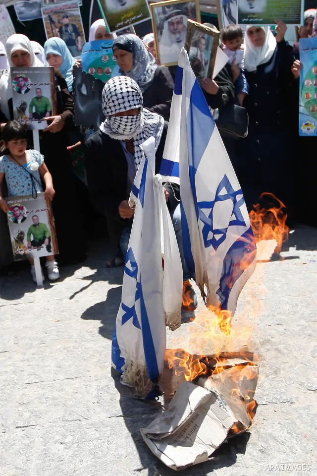 Israeli flags are burned during a rally in support of Palestinian prisoners holding a hunger strike in Israeli prisons, in the West Bank city of Ramallah May 5, 2012. Photo by Issam Rimawi