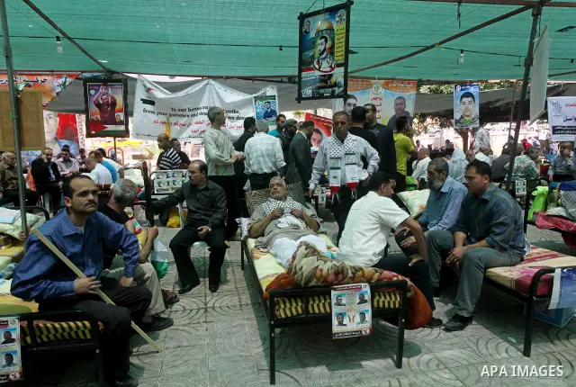 Relatives of hunger striking Palestinian inmates of Israeli prisons hold portraits during a sit-in solidarity protest in a tent, in Gaza City, Gaza Strip, on 04 May 2012. Protests continued in solidarity with hundreds of...