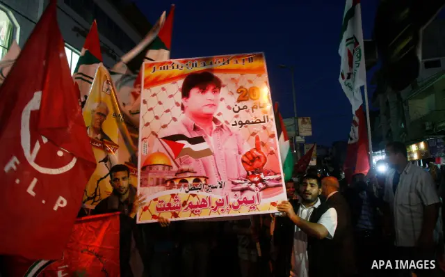 Supporters of Palestinian Democratic Front participate in a rally supporting Palestinian inmates on hunger strike since mid-April 2012, in Gaza City, May 6, 2012. A Palestinian rights group said recently that half of abo...