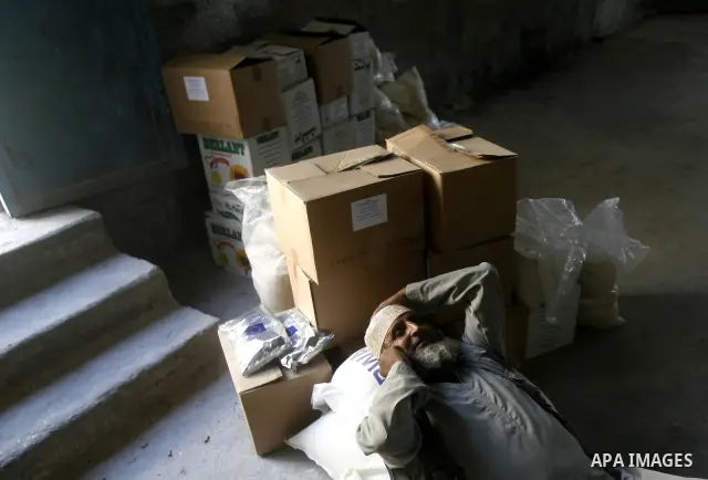 A Palestinian man receives monthly food aid from the United Nations Relief and Works Agency (UNRWA) center in the Rafah refugee camp, southern Gaza on May 07, 2012. The UN Agency for Palestinian Refugees (UNRWA) in Gaza...