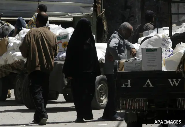 Palestinians receive monthly food aid from the United Nations Relief and Works Agency (UNRWA) center in the Rafah refugee camp, southern Gaza on May 07, 2012. The UN Agency for Palestinian Refugees (UNRWA) in Gaza launch...