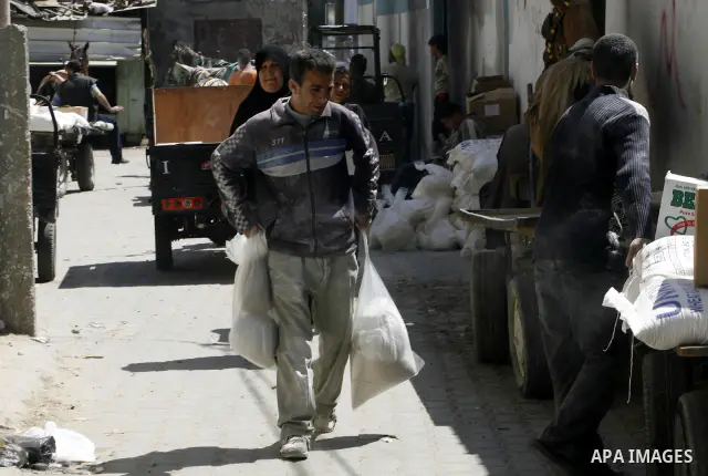 Palestinians receive monthly food aid from the United Nations Relief and Works Agency (UNRWA) center in the Rafah refugee camp, southern Gaza on May 07, 2012. The UN Agency for Palestinian Refugees (UNRWA) in Gaza launch...