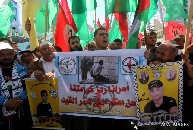 Palestinian men attend a rally in Gaza City, to show solidarity with Palestinian prisoners held in Israeli jails on May 7, 2012. At least 1,550 Palestinian prisoners are refusing food in Israeli jails in a protest agains...