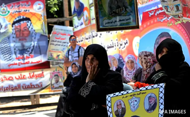 Palestinian women attend a rally in Gaza City, to show solidarity with Palestinian prisoners held in Israeli jails on May 7, 2012. At least 1,550 Palestinian prisoners are refusing food in Israeli jails in a protest agai...