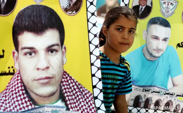 A Palestinian girl attends a rally in Gaza City, to show solidarity with Palestinian prisoners held in Israeli jails on May 7, 2012. At least 1,550 Palestinian prisoners are refusing food in Israeli jails in a protest ag...